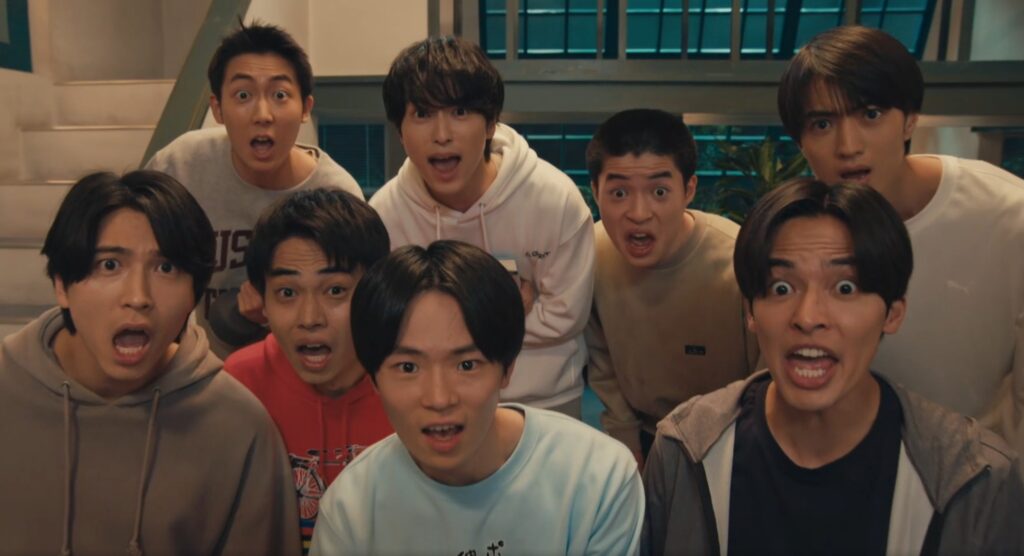 『俺たちの学連合宿』の出演者である若手男性キャスト7名が、カメラに向かって目や口を大きく見開き、驚いたような表情で一斉にこちらを見つめているワンシーン。