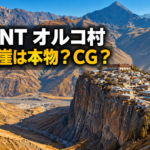 VIVANTのオルコ村をイメージした横長の生成画像。険しい山々を背景に、巨大な断崖の上へ石造りの家々と大きな建物が密集する風景を描き、「VIVANT オルコ村」「あの断崖は本物?CG?」の文字を大きく配置しています。